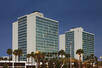 hotel building, hotel exterior, nighttime, palm trees