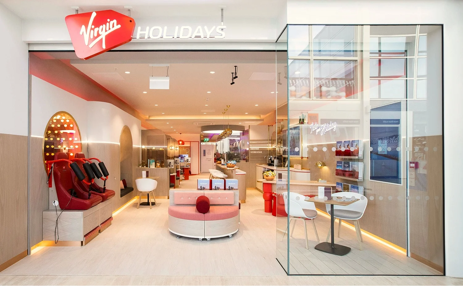 Virgin Holidays Vroom Milton Keynes storefront with lounge seating consultation tables and illuminated signs behind glass