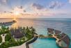 Aerial view of water villas at sunset