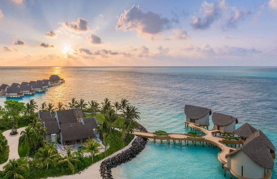 Aerial view of water villas at sunset